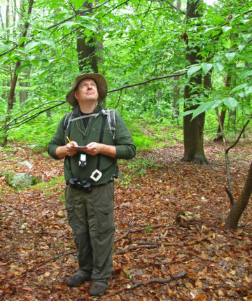 A volunteer takes data on forest birds. © Steve Faccio